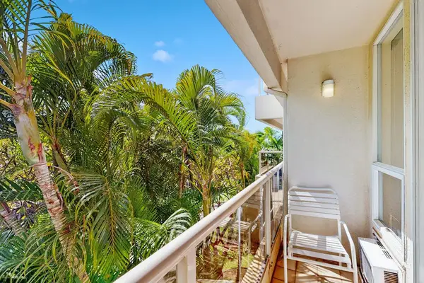 Covered lanai framed by lush greenery
