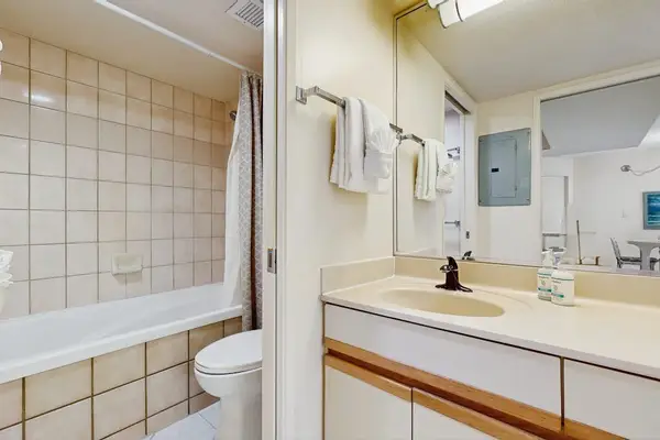 Full bathroom with a spacious vanity and tub-shower combination
