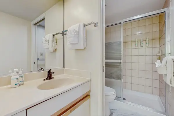 Full bathroom with spacious vanity and tub-shower combination