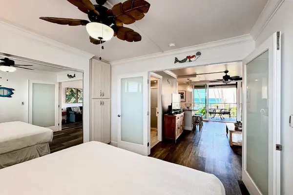 Restful bedroom presents soft linens, bedside tables, and natural light