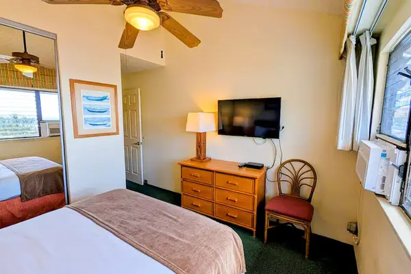 Comfortable queen bedroom with TV and ample storage