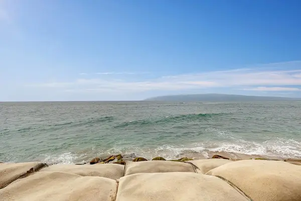 Rocky Shoreline With Endless Ocean Beauty
