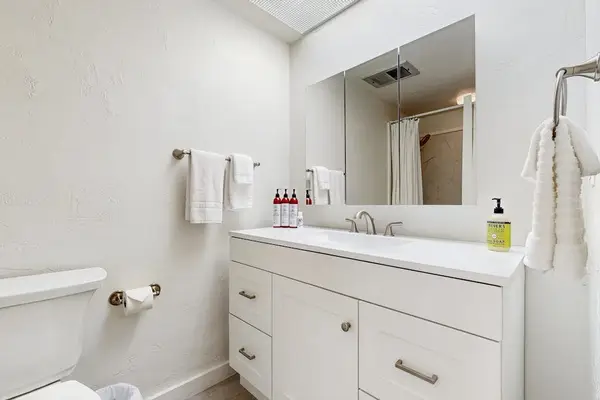 Clean Bathroom Vanity with Large Mirror & Fresh Towels