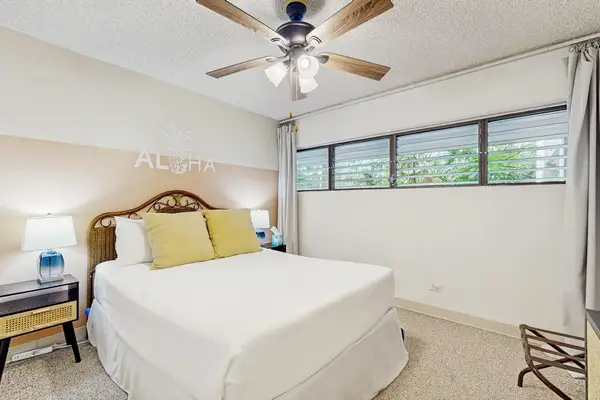 Spacious Master Bedroom with Plush Bed, Scenic Views & Ceiling Fan