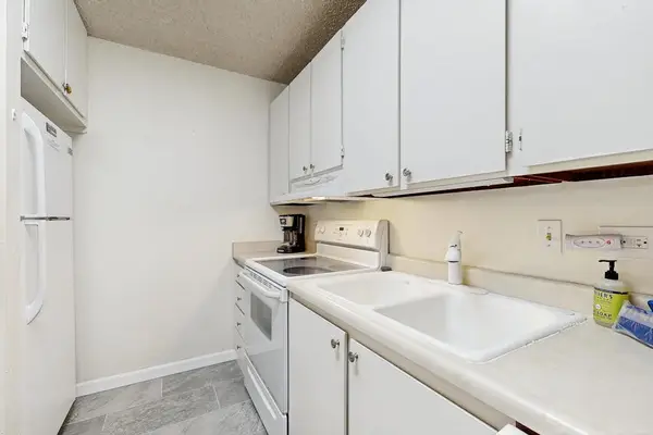 Fully Equipped Kitchen with Ample Countertops & White Cabinetry