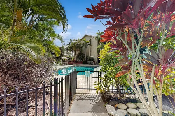 Resort-Style Community Swimming Pool surrounded by Tropical Landscaping