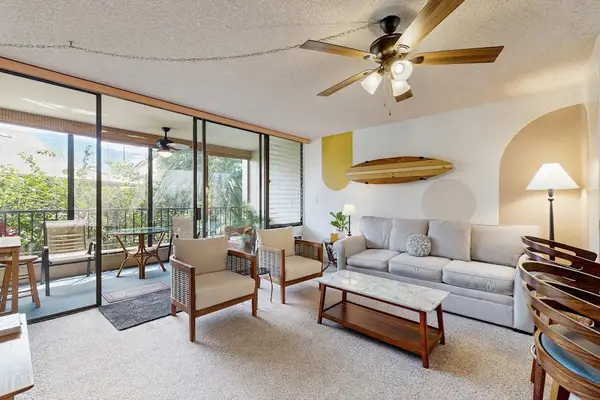 Open-Concept Living Room with Surf Decor & Direct Balcony Access