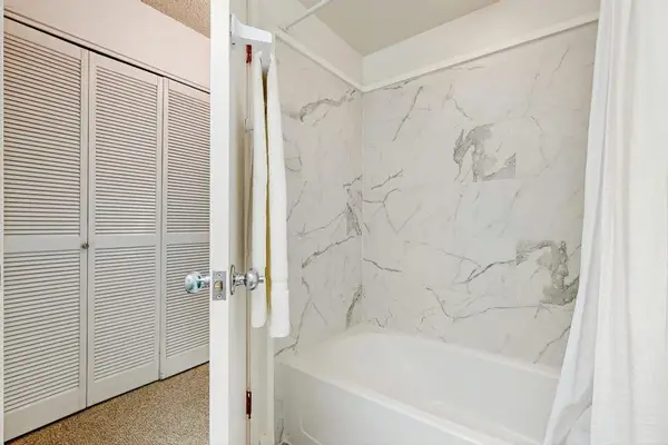 Modern Bathtub & Shower Enclosure with Marbled Tile & Glass Doors
