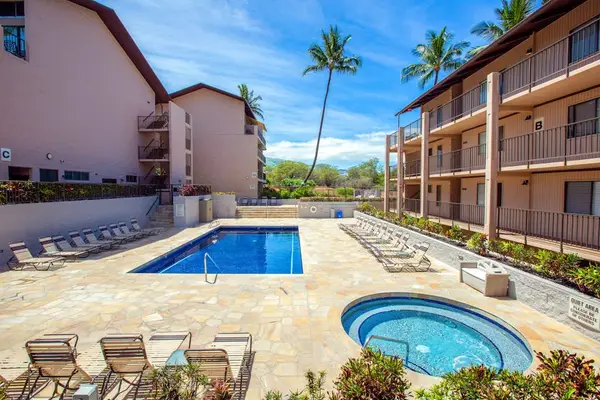 Resort Pool and Hot Tub Area with Sun Loungers & Palms
