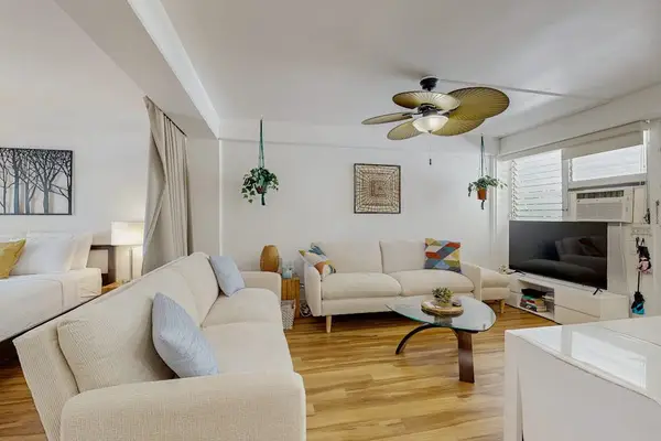 Relax and enjoy a comfortable living space featuring a TV and ceiling fan for entertainment and added comfort.