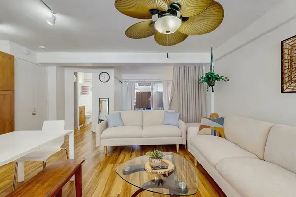 Unwind in this inviting living room with a cozy setup, entertainment options, and a refreshing ceiling fan.