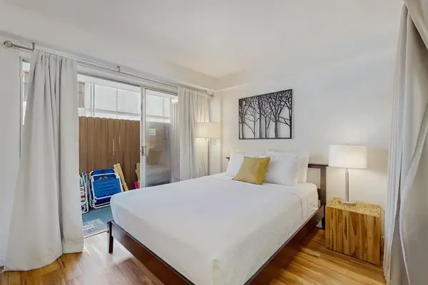 Enjoy a comfortable and restful night’s sleep in a cozy bedroom featuring a queen-size bed.