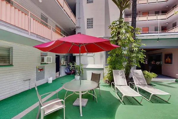 Relax under the sun or enjoy the shade with comfortable loungers and an umbrella by the pool.