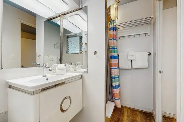 A comfortable bathroom featuring a refreshing shower for your daily convenience.