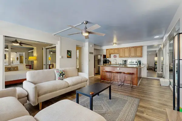 Experience a comfortable stay in this charming living room with a refreshing ceiling fan.