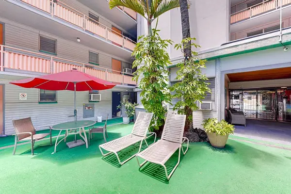 Unwind poolside with a relaxing setup featuring comfortable loungers and a shaded umbrella area.