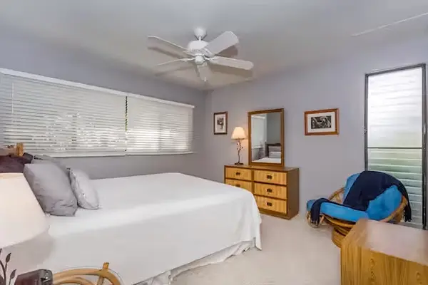 First bedroom offers a comfortable bed dresser and natural light
