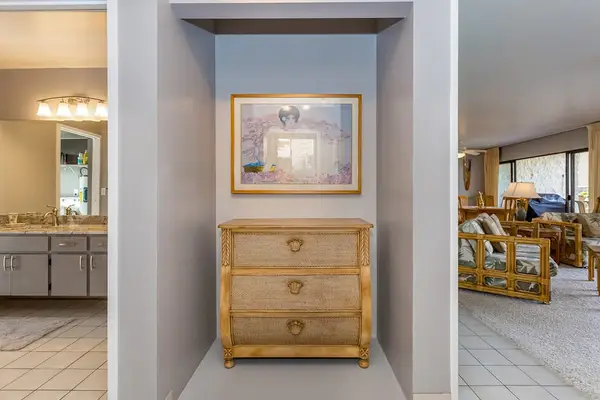 Entry hallway connects living spaces with storage and island artwork