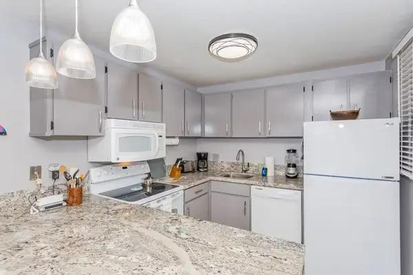 Bright kitchen offers counters appliances and convenient breakfast preparation space