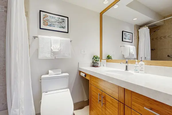 Bright Bathroom with a Large Mirror