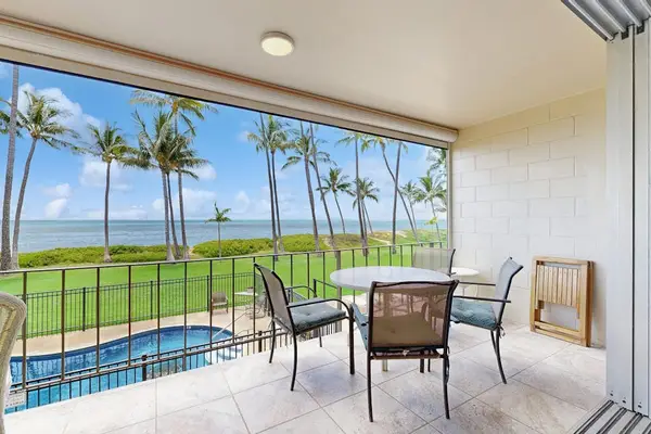 Lanai with ocean front views of the Pacific Ocean and swaying palm trees.