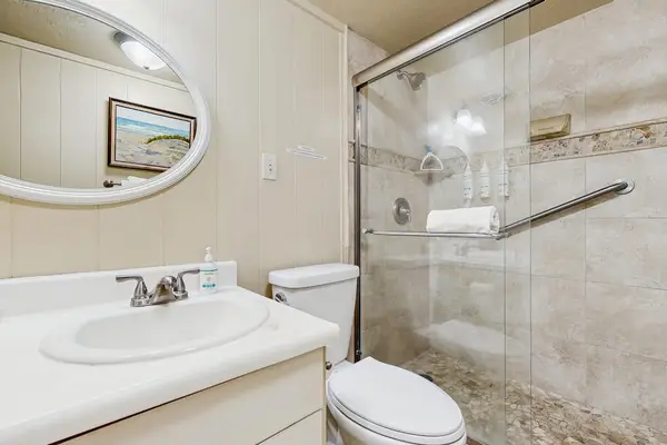 Newly remodeled guest bedroom with walk in tiled shower.