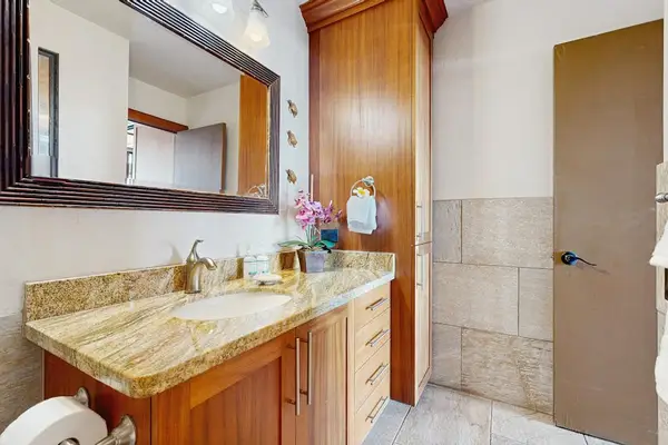 Spacious Warm Wood Vanities Offer Plentiful Storage Space