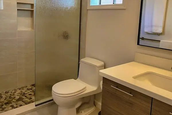 Full Bathroom features glass shower vanity and natural window light