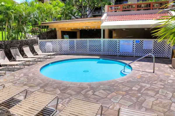 Refreshing resort pool surrounded by tropical landscaping