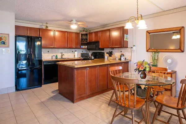 Full kitchen with breakfast bar and dining area