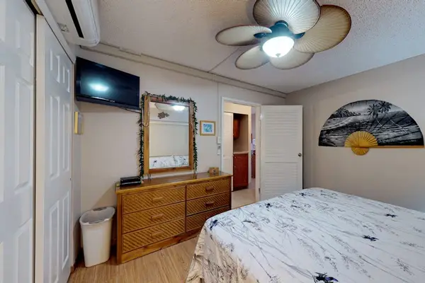 Cozy bedroom with dresser and TV