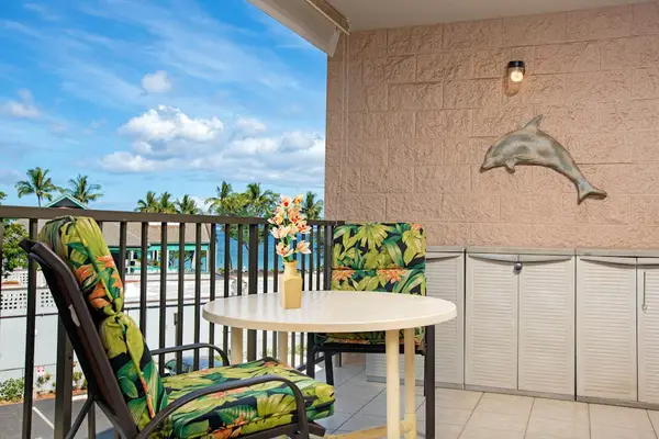 Cozy lanai with outdoor seating and tropical views