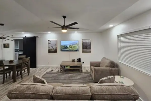 Large living room with a sofa bed and a flat screen tv.  The open concept design allows for you to stay connected to everyone.