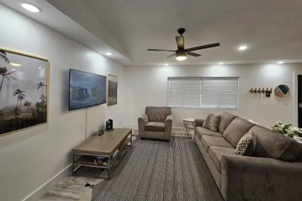 Large living room with a sofa bed and a flat screen tv.  The open concept design allows for you to stay connected to everyone.
