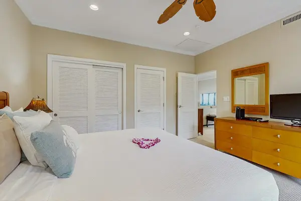 Master bedroom with king bed, flat screen tv and an ensuite bathroom.