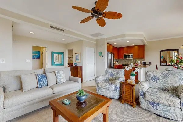 Living room with sleeper sofa, flat screen tv and lanai access.