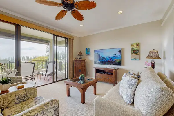 Living room with sleeper sofa, flat screen tv and lanai access.