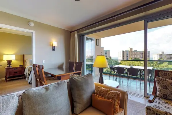 Cozy living and dining area featuring a comfortable armchair and warm lighting, perfect for relaxing with a good book.