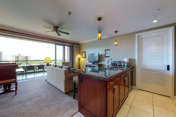 Convenient kitchen space with granite countertops, ideal for making food while enjoying the open living area.