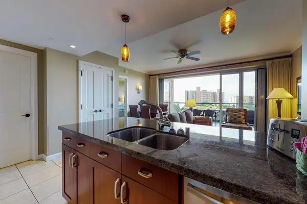 Kitchen island with a double sink and convenient amenities, including a toaster, perfect for preparing your daily meals with ease.