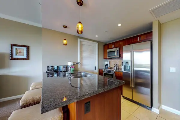 Fully equipped kitchen with a spacious refrigerator and microwave, perfect for preparing meals and keeping your drinks fresh throughout your stay.
