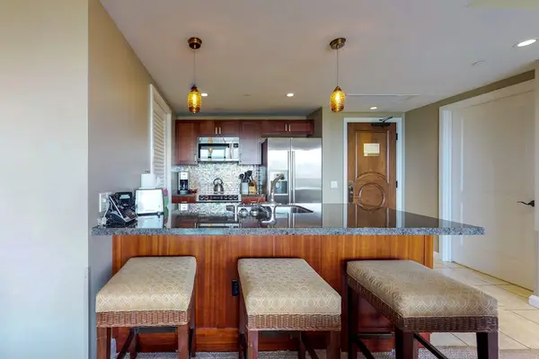 Kitchen island with comfortable bar stools, perfect for sharing casual meals or enjoying a few drinks together.