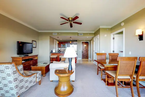 Beautiful dining space to share meals with loved ones, flowing perfectly into a cozy living area with comfortable seating and a TV.
