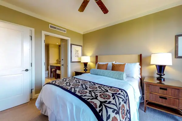 Inviting bedroom setup with a spacious bed, stylish accent pillows, and an attached bathroom for ultimate privacy and convenience.
