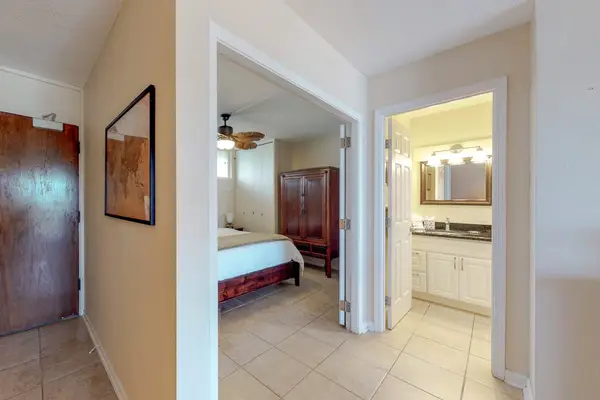 Featuring tile flooring throughout the hallway and bedroom entrance