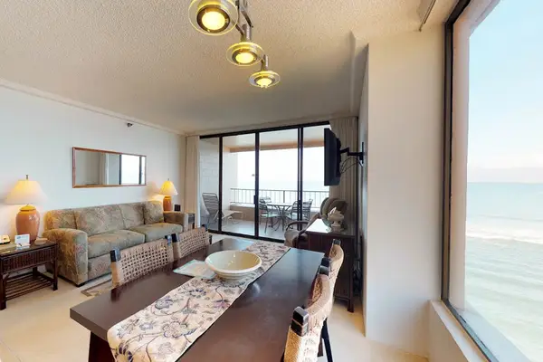 Dining room with seating for five and a view out of the picture window.