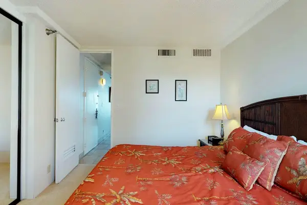 Master bedroom with lots of natural light and king bed.
