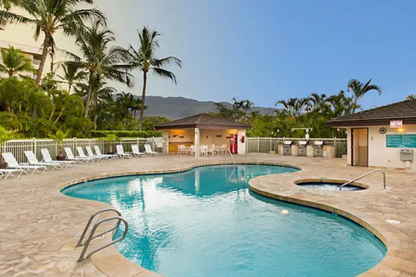 Resort pool surrounded by tropical greenery