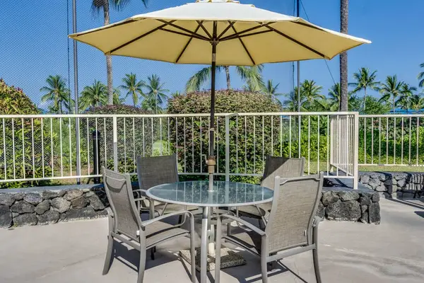 Sunny Patio Dining Area with Large Shade Umbrella