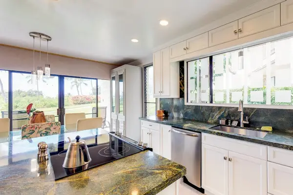 Modern Kitchen Setup with Stainless Steel Dishwasher & Large Windows